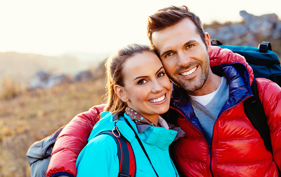 Happy couple hiking in the mountains